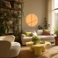Wide shot of a sunlit living room with an orange wall glow