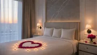 Wide establishing shot of the bedroom showing bed, petals, and balloon banner.