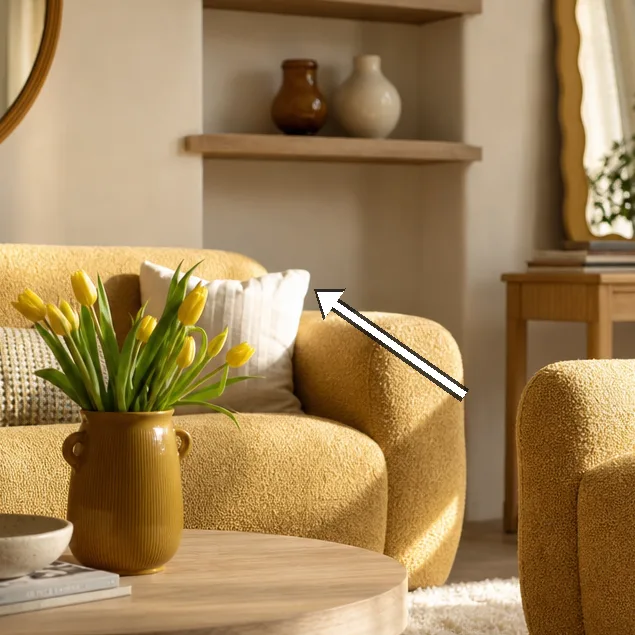 Soft boucle armchair and sofa with cushions bathed in light
