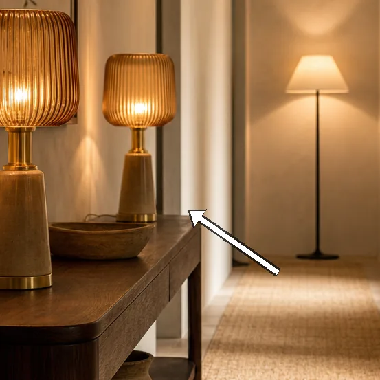 Bronze fittings and linen shade textures glow against ivory plaster.