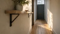 Wide view of narrow hallway showing slim oak console, muted slate blue door